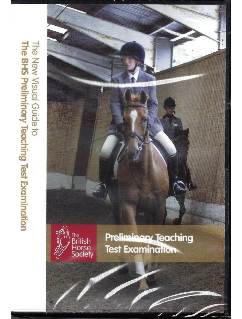 Cover of the DVD titled 'THE NEW VISUAL GUIDE TO THE BHS PRELIMINARY TEACHING STAGE EXAM,' featuring a person riding a horse in an indoor arena, with the British Horse Society logo visible.