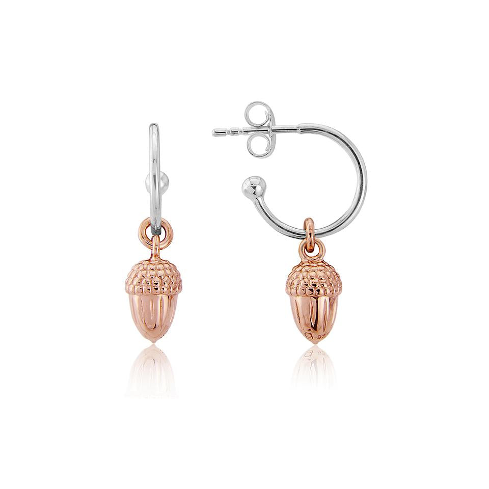 A pair of rose gold acorn hoop earrings with sterling silver and 14ct rose gold vermeil. The earrings feature a small acorn charm attached to the hoop.