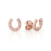Rose gold horseshoe earrings with small diamonds on a white background