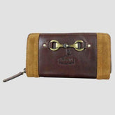 A brown leather and suede purse with a metallic snaffle bit closure, featuring suede detailing and brand embossing.