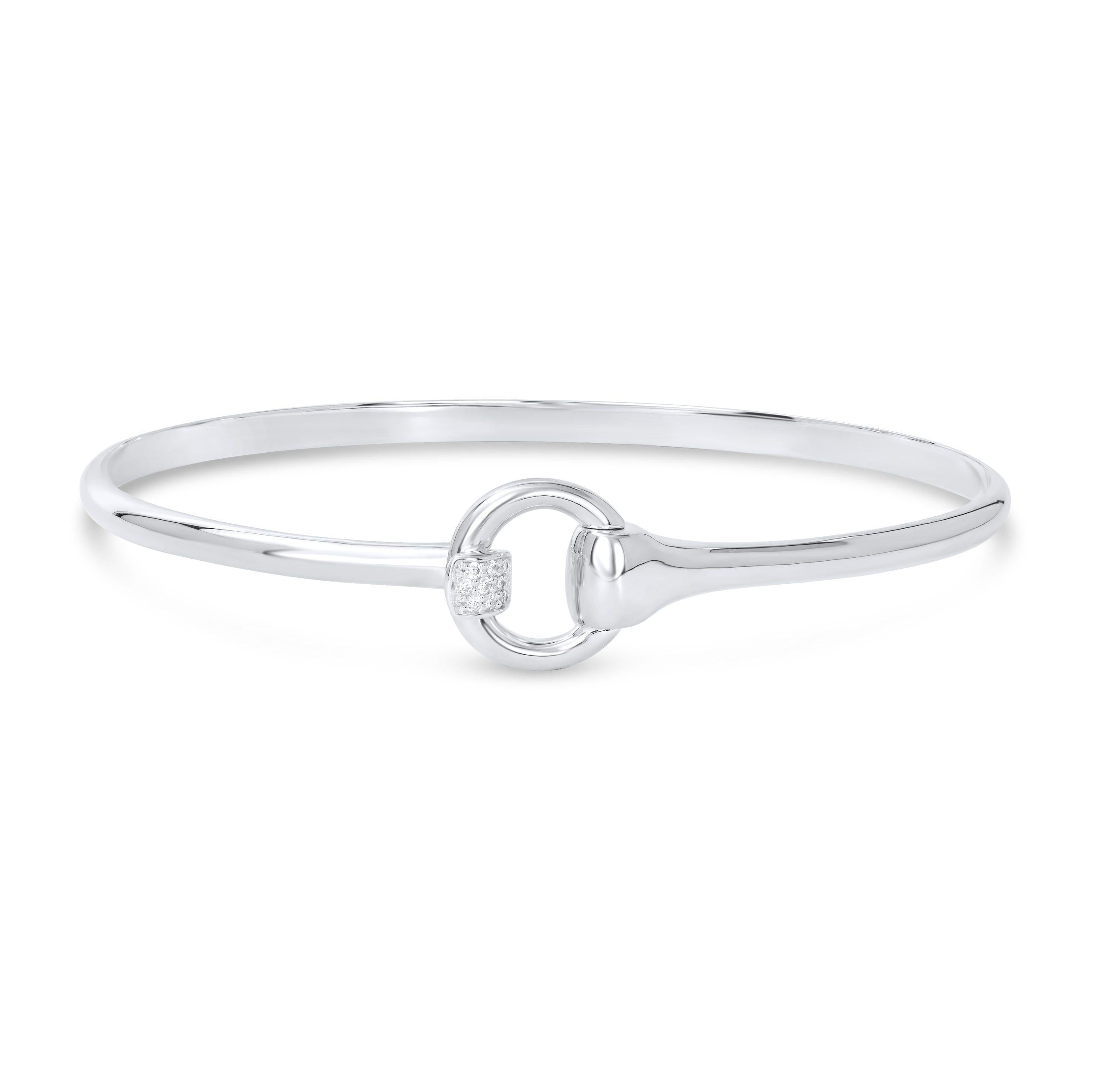 A solid sterling silver bangle bracelet with a snaffle bit design and sparkly cubic zirconia stones, presented against a white background.