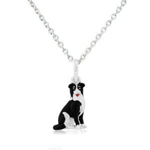A sterling silver pendant in the shape of a black and white collie dog with a silver chain.