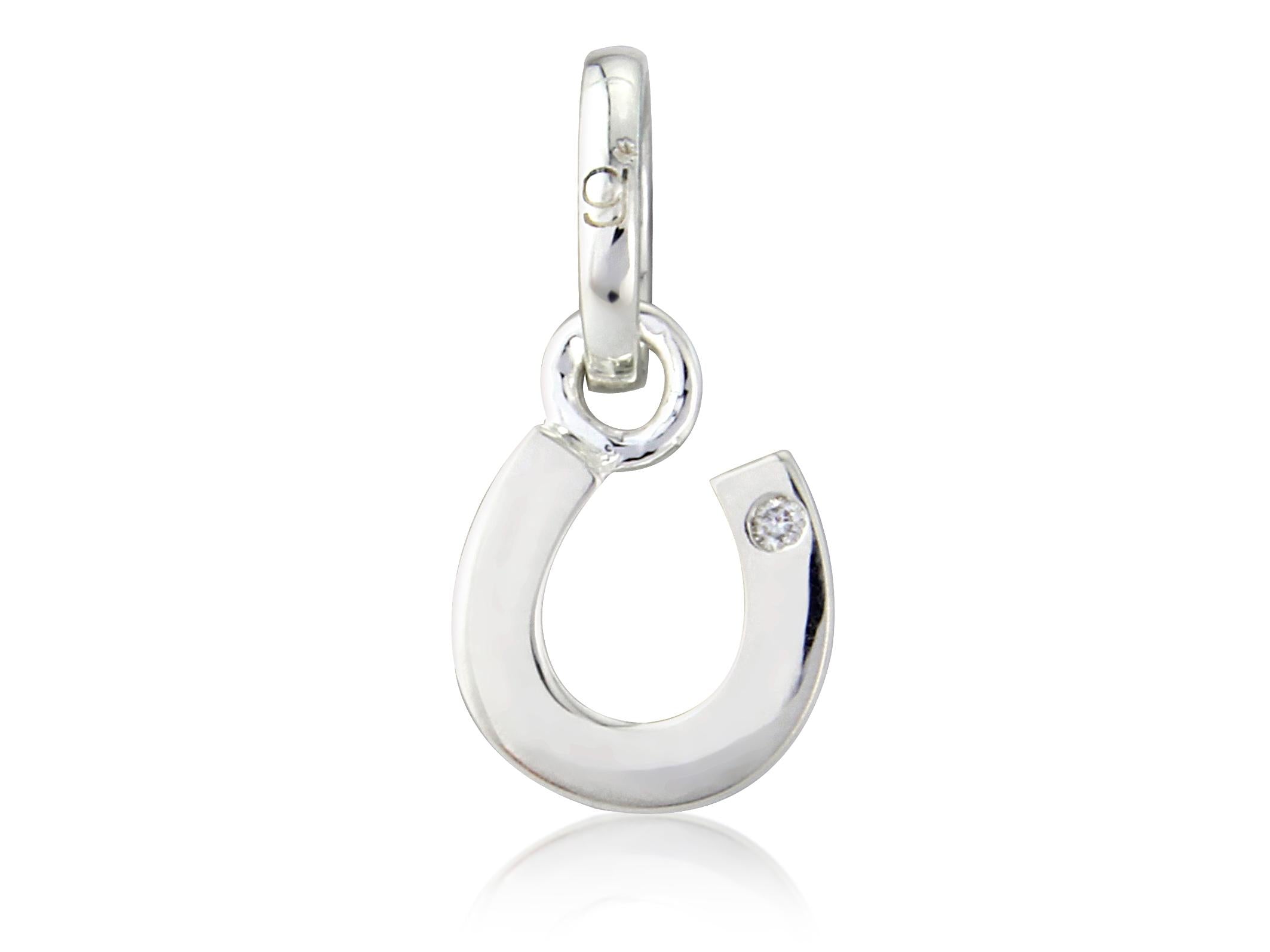 A sterling silver horseshoe charm with a small diamond in the center, attached to a loop on top for a chain or bracelet.
