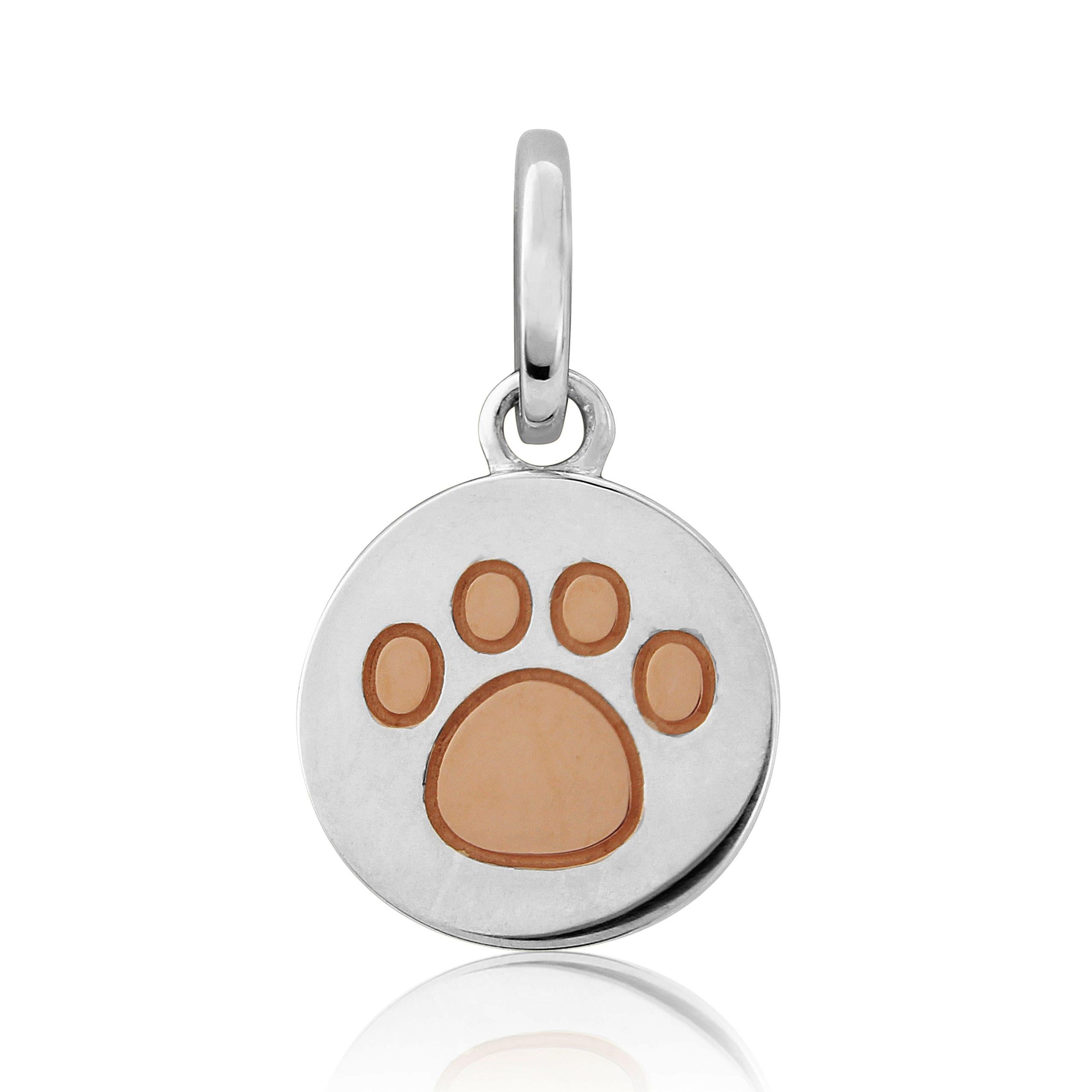 A sterling silver charm featuring a rose gold embossed dog paw print on a silver disc.