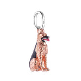 A sterling silver German Shepherd charm with rose gold coating and black and pink enamel detailing.