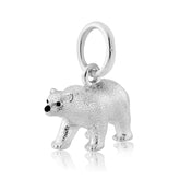 A sterling silver charm shaped like a polar bear with a loop for a necklace chain.
