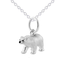 A sterling silver pendant in the shape of a polar bear, displayed on a silver chain against a white background.