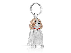 A sterling silver charm featuring a curly haired dog, possibly a Springer Spaniel, with rose gold highlights over its head and neck.