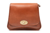 A soft tan Irish leather handbag with a flap closure and a metal buckle, featuring an adjustable leather shoulder strap.