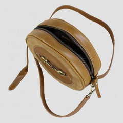 tan leather and suede bag above view with zip open and strap visible