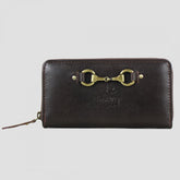 A brown leather zip-around purse with a metallic snaffle-bit fitment and embossed logo, featuring multiple compartments for cards and cash.