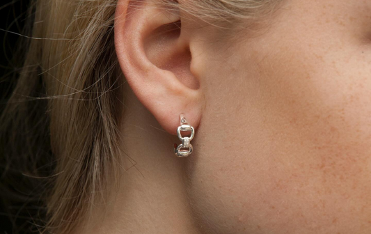 lady with gold earring snaffle style in ear