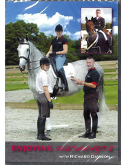 Cover of 'ENJOYING DRESSAGE VOL 2' featuring a person on horseback with a trainer standing beside the horse. The horse is white and the trainer is wearing a black shirt and pants.
