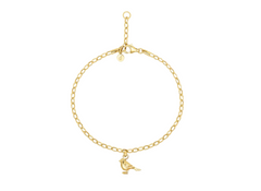 Gold bracelet with a small bird charm on a white background