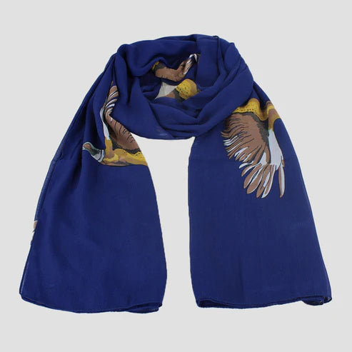 A blue chiffon scarf with a pheasant artwork design spread out on a plain surface.