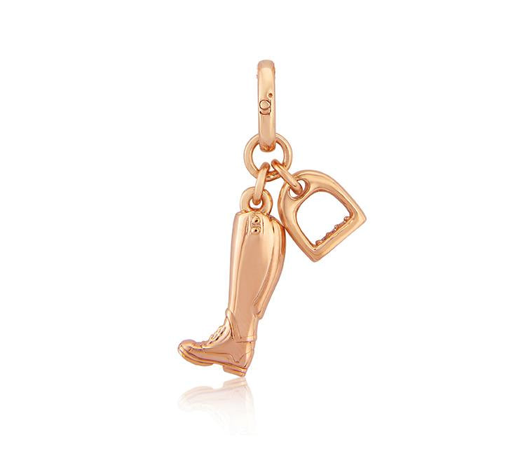 A 14 ct rose gold charm featuring a riding boot and stirrup, suspended from a loop, against a white background.