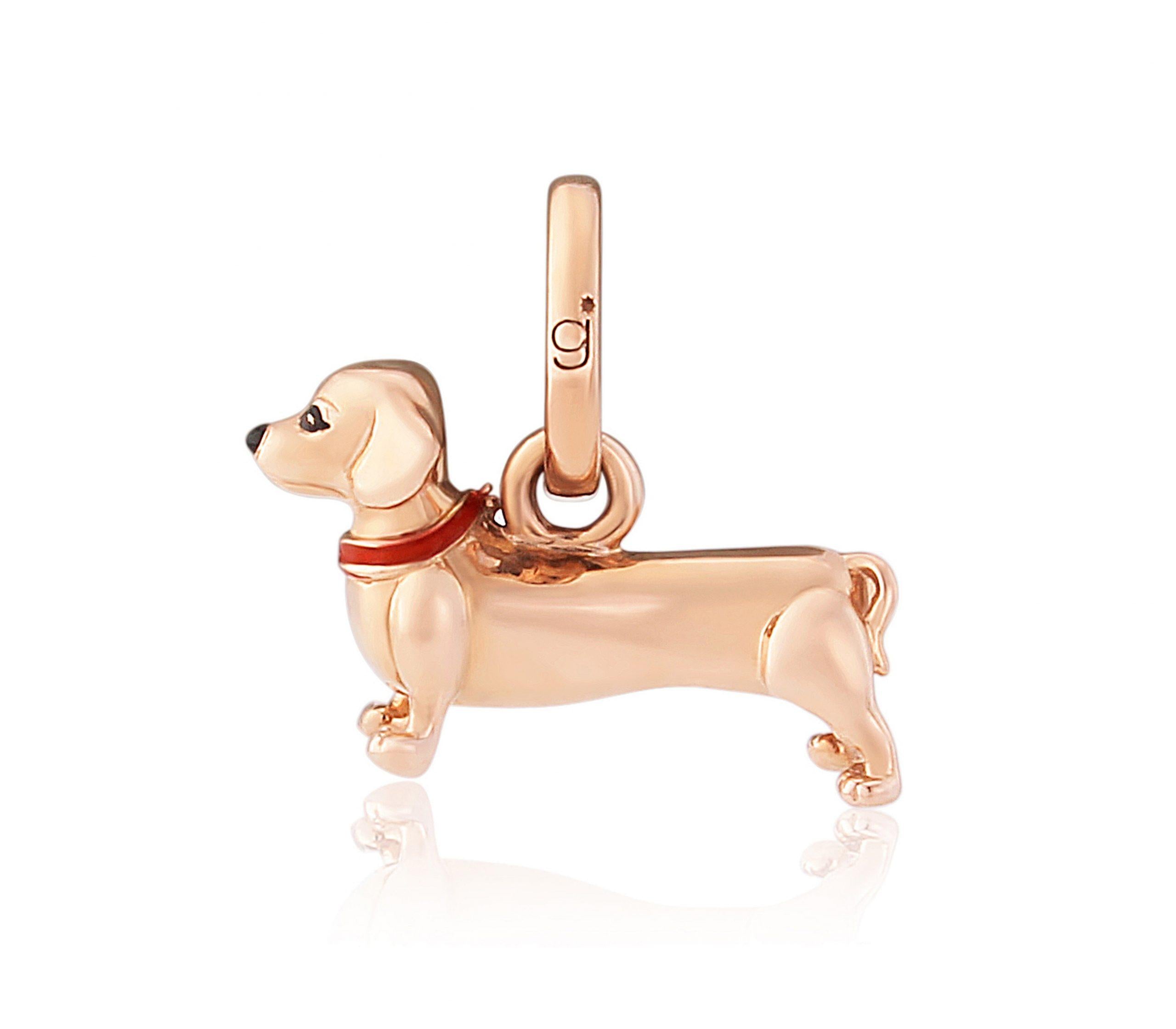A rose gold-colored Dachshund dog charm with a red enamel collar, suitable for wearing on a charm bracelet or chain.