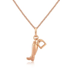 A rose gold pendant featuring a riding boot and stirrup with a chain attached, set against a white background.