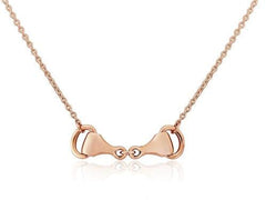 A rose gold snaffle bit necklace with an adjustable chain, presented against a white background.