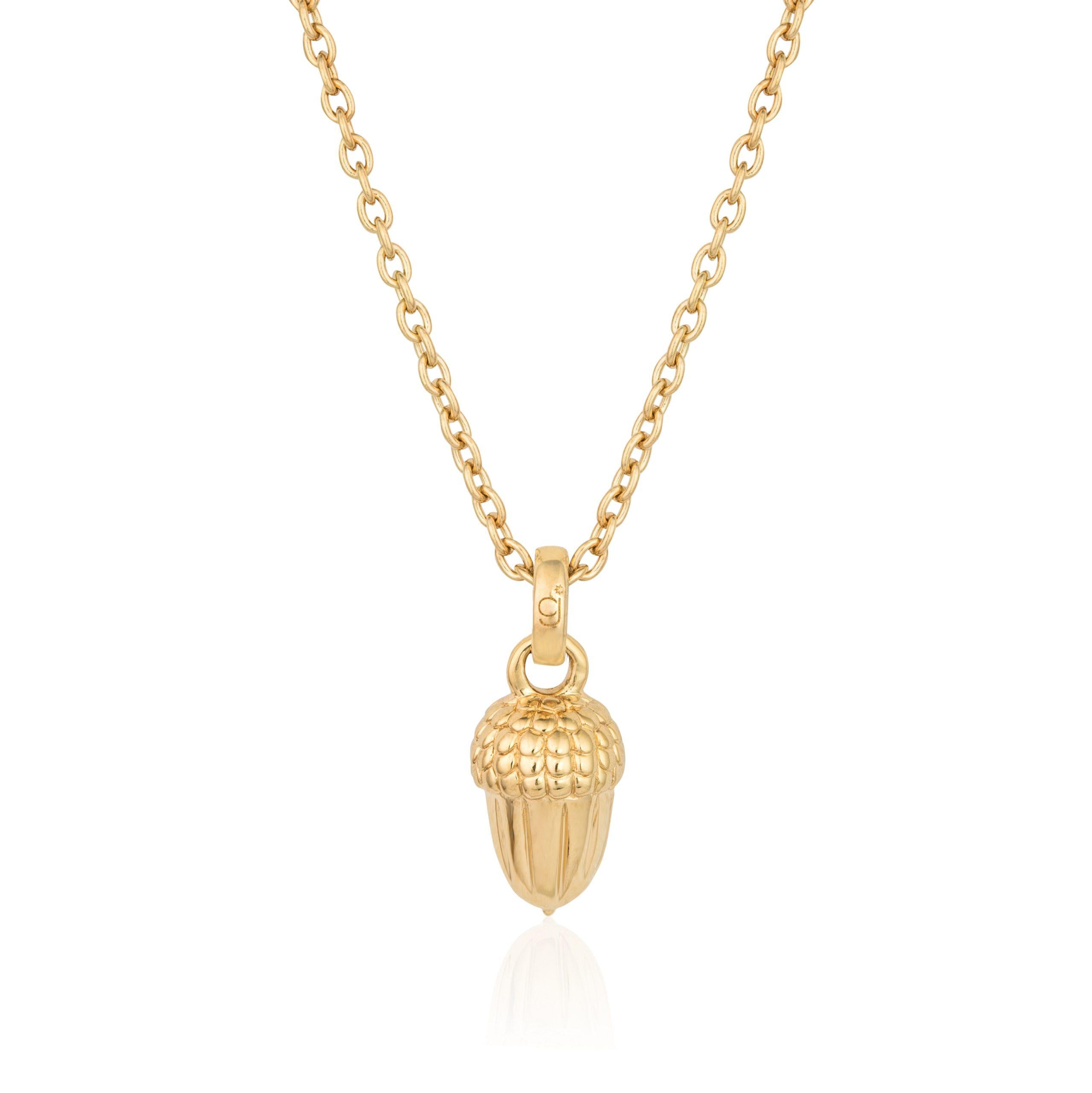 A rose gold necklace with a sterling silver acorn charm on an adjustable yellow gold chain.