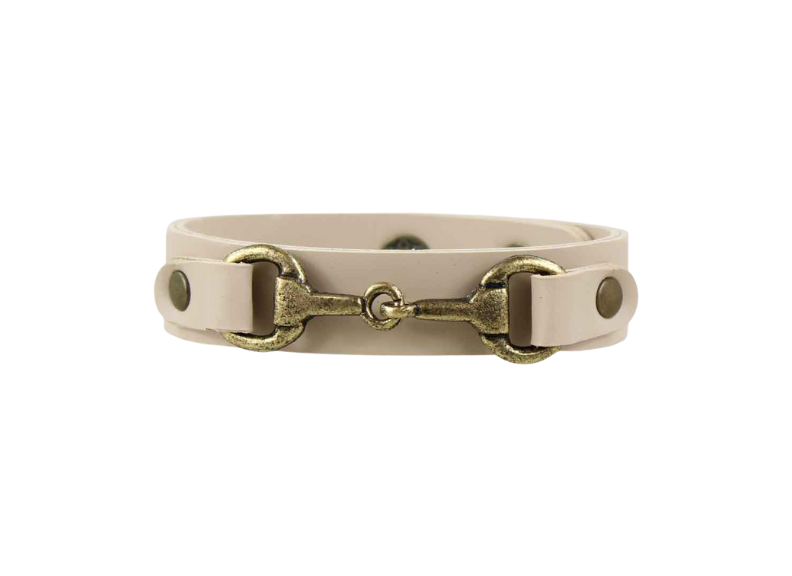 Beige leather bracelet with brass horse bit design on a white background