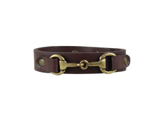 Brown leather bracelet with brass horse bit clasp on a white background