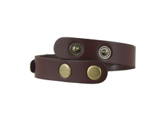 Brown leather bracelet with brass buttons on a white background