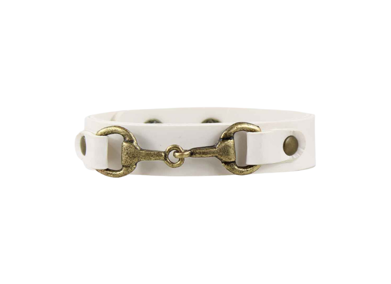 White leather bracelet with brass horse bit clasp on a white background