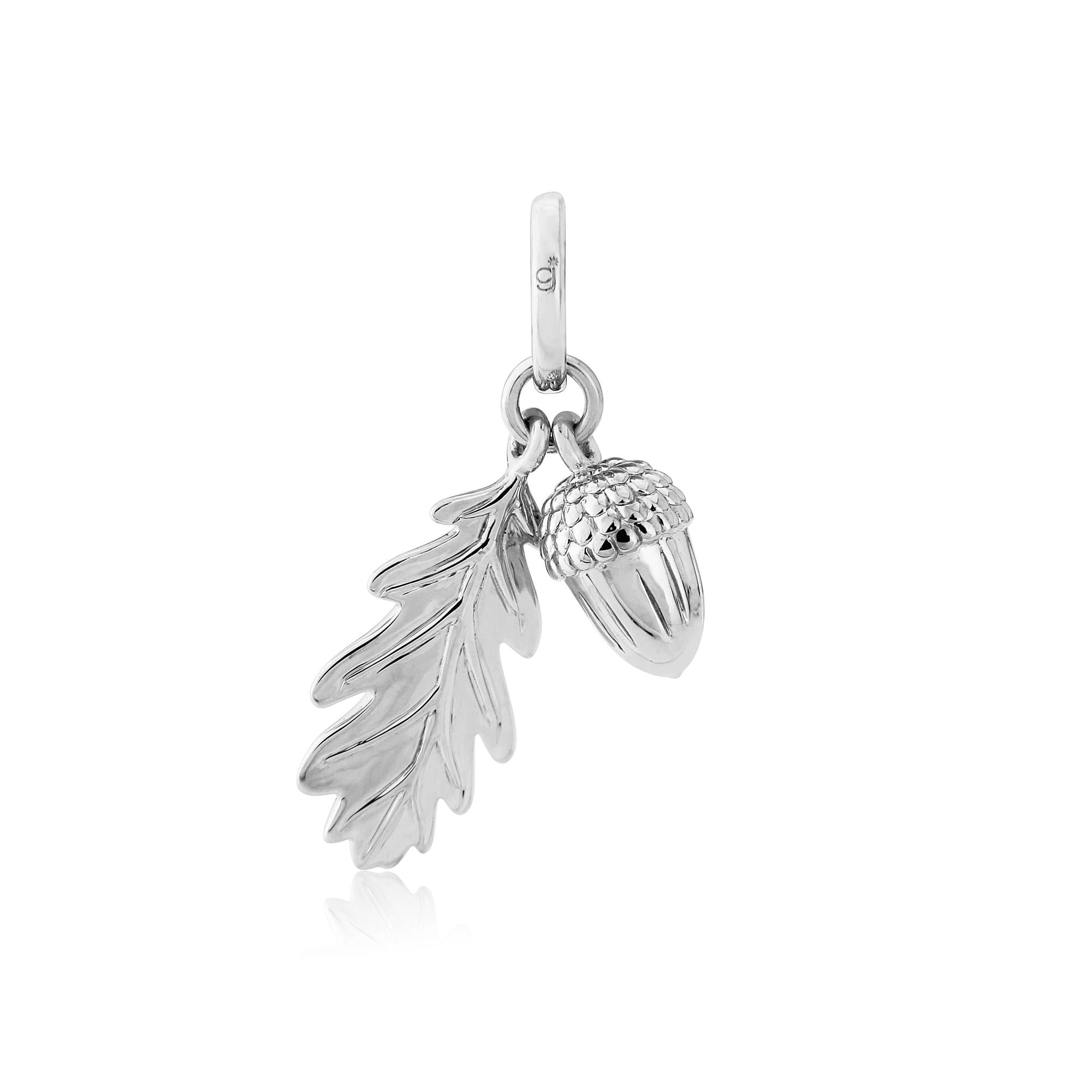 A sterling silver charm featuring a leaf and acorn design.