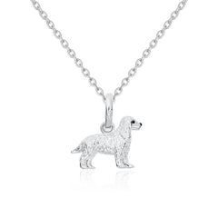 Silver dog pendant on a chain against a white background