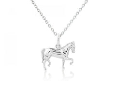 A sterling silver pendant in the shape of a dressage horse in motion, accompanied by an adjustable sterling silver chain.