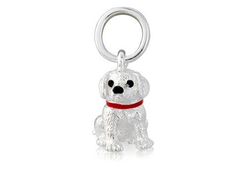 A sterling silver pendant in the shape of a young Labrador puppy with a red collar, accompanied by a loop for attachment, against a white background.