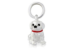 A sterling silver pendant in the shape of a young Labrador puppy with a red collar, accompanied by a loop for attachment, against a white background.