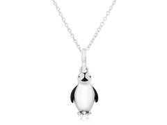 A sterling silver pendant in the shape of a penguin with black and white enamel detailing, attached to a silver chain.
