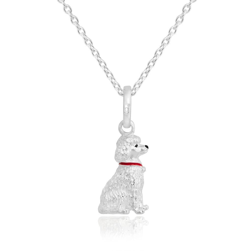 A sterling silver pendant in the shape of a poodle with a red enamel collar, attached to a silver chain.