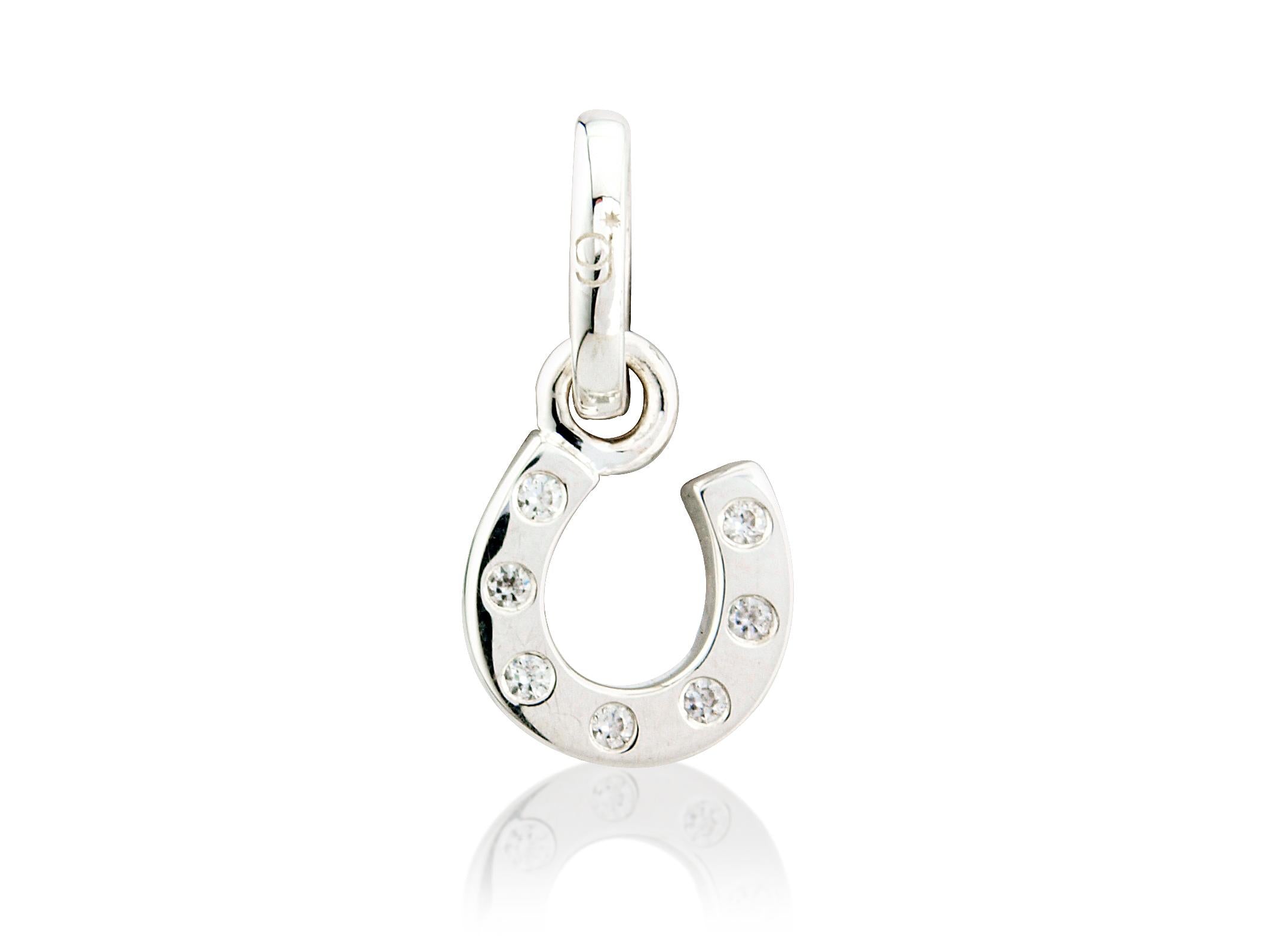 A sterling silver horseshoe charm with cubic zirconia stones embedded within it.