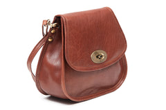 A soft tan Irish leather shoulder bag with a flap closure and a mobile phone pocket on the back panel.