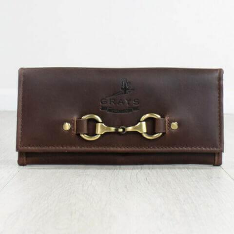 A dark brown leather purse with a metallic snap closure and embossed logo.