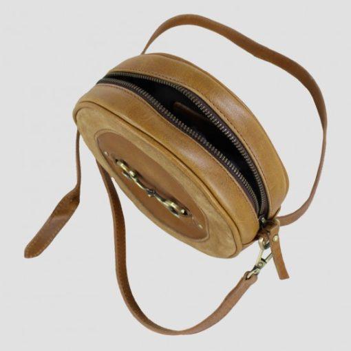 tan leather and suede bag above view with zip open and strap visible 