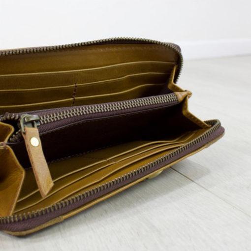 tan leather suede purse from above angle with zip open showing compartments for cards and cash