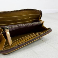 tan leather suede purse from above angle with zip open showing compartments for cards and cash