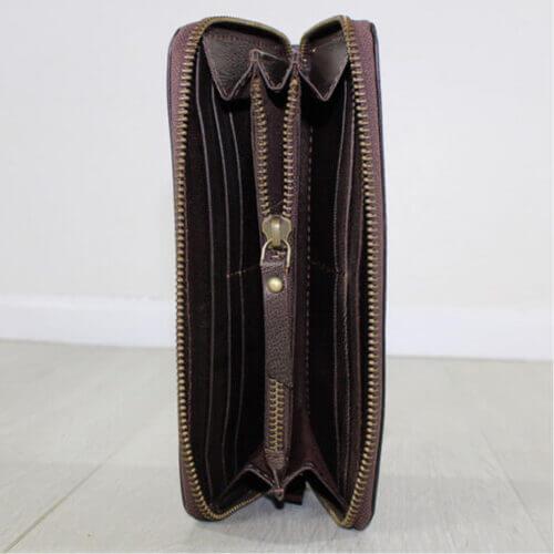 brown leather purse open showing compartments and zip