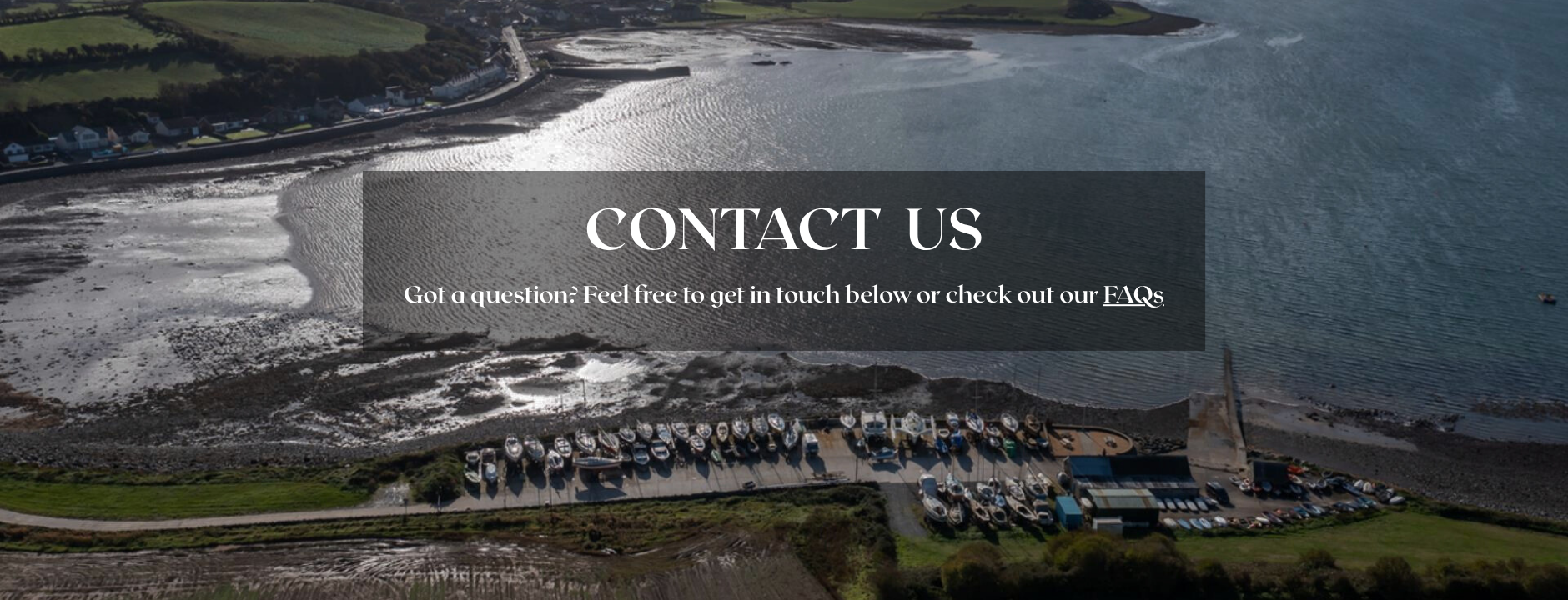 Majestic landscape with a body of water and mountains, featuring a contact us message overlay.