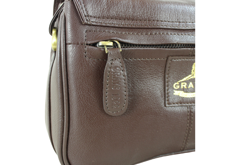 Brown leather handbag with a visible brand logo on a white background
