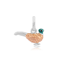 A sterling silver charm shaped like a pheasant with a rose gold coating on its plumage, green beak and silver feathers.